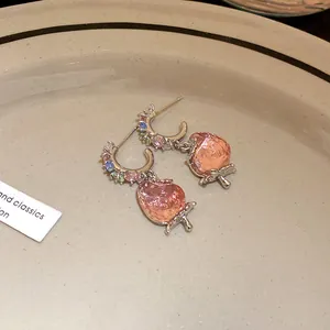 Detailed close-up of sweet pink strawberry drop earrings with colorful crystal hoop decoration