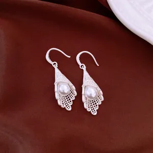 Elegant silver-tone hollow lace cone earrings with white pearl drop detail, high quality