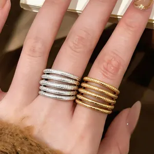 Detailed macro view showing the textured multi-layer hollow design of 18k gold plated open rings