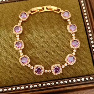 Detailed view of a vintage gold-plated bracelet with purple zircons and square accents.