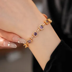 Detailed macro view of vintage gold-plated bracelet with purple cubic zirconia stones