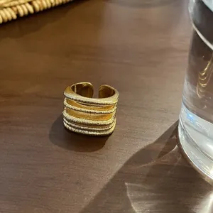 Close-up view of textured 18k gold plated multi-layer open ring