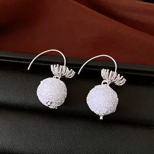 Detailed view of elegant crystal floral round bead drop earrings with silver hooks