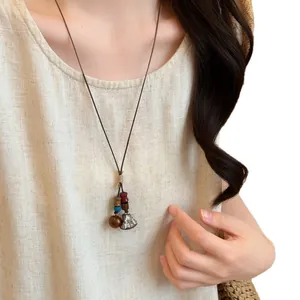 Handmade forest style acorn pendant necklace with long woven rope chain for women.