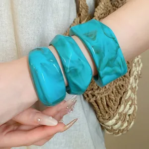 Stylish set of irregular marbled turquoise cuff bracelets for a chic bohemian look
