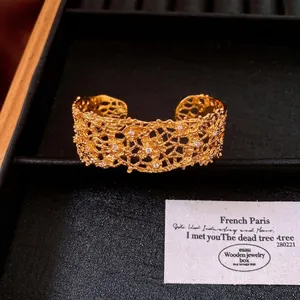 Elegant gold-toned lace hollow cuff bracelet with sparkling crystal accents for women