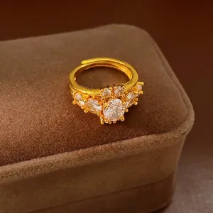 Vintage style gold plated ring with oval zirconia stones on a brown velvet jewelry box
