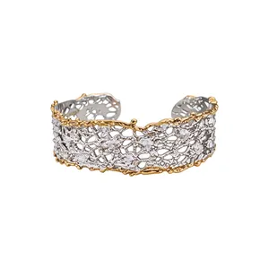 Artistic handcrafted hollow lace cuff bracelet in gold and silver tones for women.