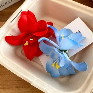 Vacation-style fabric flower hair clips set in vibrant red and sky blue colors