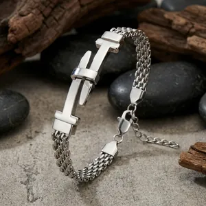 Detailed view of silver stainless steel mesh bracelet with belt buckle plate design