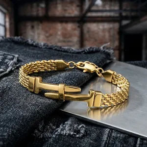 Macro view of a men's gold stainless steel mesh chain bracelet with T-buckle design