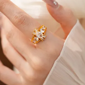 Detailed view of a gold-plated court style ring with sparkling oval and round zircons
