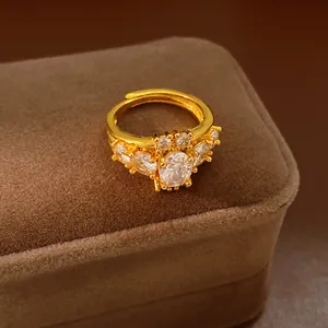 Macro detail of a vintage gold-plated ring with an oval zircon centerpiece on a velvet box.