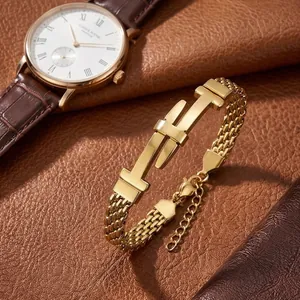 Detail of gold stainless steel bracelet with belt buckle design and mesh chain texture