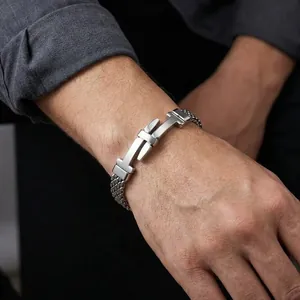 Close-up of men's stainless steel mesh woven bracelet with belt buckle design