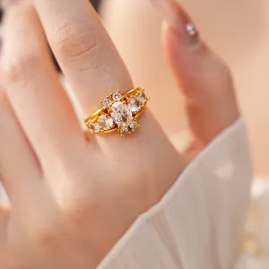Macro view of gold-plated ring with sparkling oval and round cubic zirconia