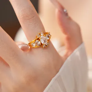 Close-up detail of a vintage palace style gold ring with sparkling oval zircons