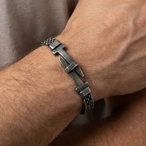 Detail view of mens stainless steel bracelet with belt buckle design and mesh chain