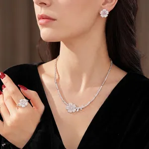 Elegant zircon flower jewelry set with necklace and ring on a model in black velvet