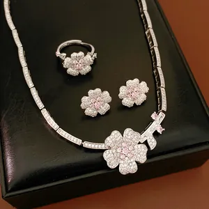 Close-up view of zircon flower jewelry set including necklace, ring, and earrings