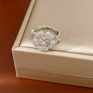 Macro detail view of an elegant silver flower ring with pink and clear zircons.