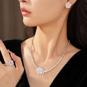Elegant zircon flower jewelry set featuring necklace, earrings, and ring on model.