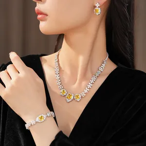 Detailed view of luxury jewelry set with square yellow zircons on necklace and bracelet