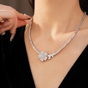 Close-up view of an elegant flower necklace with pavé zircons worn on a model's neck