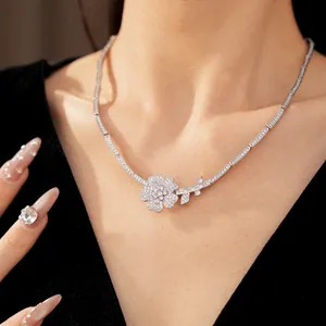 Detailed close-up view of an elegant silver flower necklace with pink and white cubic zirconia