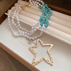 Multi-layer pearl and turquoise bead necklace with large gold star pendant