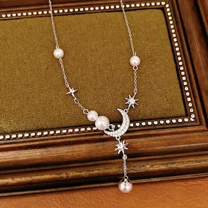 Elegant silver star and moon pendant necklace featuring pearls and zircon tassels design