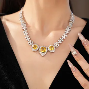 Close-up of elegant necklace with square yellow zircons and white crystals