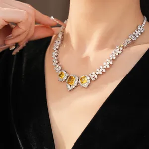 Detailed view of a vintage luxury necklace with yellow square stones on model's neck