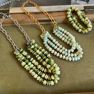 Detailed close-up of handmade green shell bead multi-strand necklaces and matching bracelet