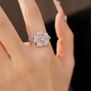 Detailed close-up of a sparkling zircon flower ring with pink and white stones.
