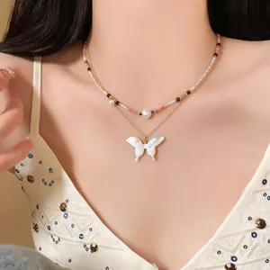 Close-up of French-style double-layer beaded necklace with white butterfly pendant on model