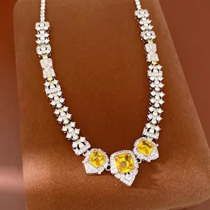 Detailed macro shot of palace style silver necklace with square yellow zircon gemstones