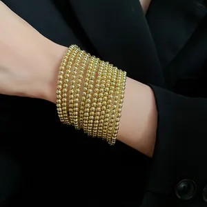Stackable multi-layer gold round bead bracelets for elegant women's jewelry look