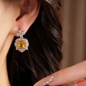 Close-up of elegant yellow square zircon drop earring in vintage palace style