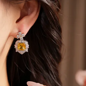 Close-up of elegant square yellow zircon drop earrings in a luxury vintage style