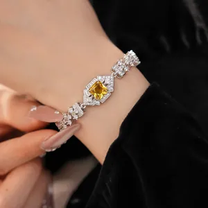 Close-up detail of luxury palace-style bracelet with square yellow gemstone and zircons