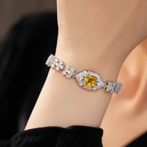 Detailed macro view of an elegant silver bracelet featuring a central yellow square zircon