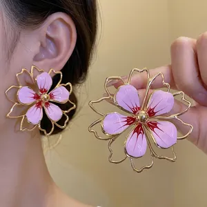 Oversized pink enamel flower drop earrings with vintage gold-tone outline design