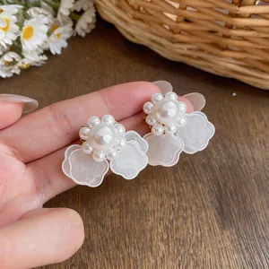 Detalle macro de pendientes de botón de flor con perlas elegantes y pétalos traslúcidos