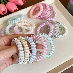 Bunte spiralförmige Telefonkabel-Haargummis mit Perlenakzenten und gesprenkelten Designs