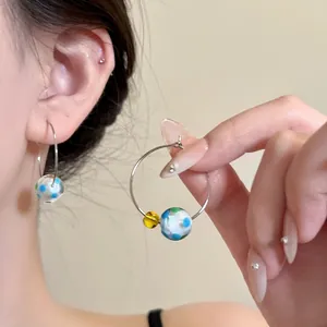 Stylish dopamine resin hoop earrings with colorful polka dot beads worn by model