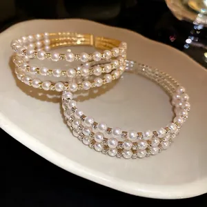 Elegant multi-layer gold open bangle bracelet with white pearls and sparkling rhinestones.