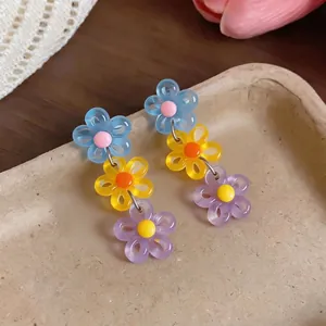 Vibrant dopamine style multi-color acrylic daisy drop earrings for a sweet summer look
