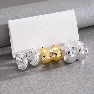 Close-up of a 6-piece C-shaped hoop earring set with textured and smooth finishes.