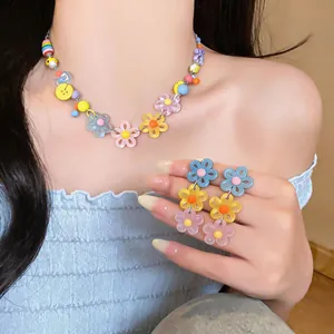 Vibrant dopamine style colorful daisy necklace and floral drop earrings set on model